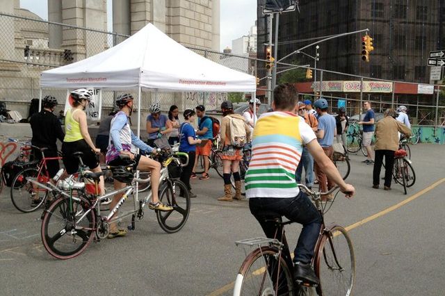 Transportation Alternatives volunteers greet cyclists this morning on the Manhattan Bridge.